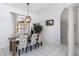Formal dining room featuring tile floors, modern light fixture, and a large window at 25179 Campos Dr, Punta Gorda, FL 33983
