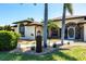 Charming single-story home with elegant arched windows, a well-manicured lawn, and lush landscaping at 25179 Campos Dr, Punta Gorda, FL 33983