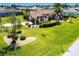 A well-manicured front yard shows a house and flagpole at 25179 Campos Dr, Punta Gorda, FL 33983