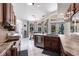 Kitchen with tiled floors, wood cabinets, breakfast bar, and views of the screened lanai with pool at 25179 Campos Dr, Punta Gorda, FL 33983