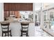 Kitchen breakfast bar overlooks the dining area and screened lanai with a swimming pool at 25179 Campos Dr, Punta Gorda, FL 33983