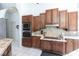 Well-equipped kitchen offers wood cabinets, stainless steel appliances, and a breakfast bar at 25179 Campos Dr, Punta Gorda, FL 33983