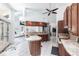 Bright kitchen with wood cabinets, an island, and access to the dining room, living room, and lanai at 25179 Campos Dr, Punta Gorda, FL 33983