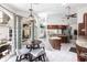 Open kitchen with breakfast nook, island, wood cabinets, and views of the dining room and the living room at 25179 Campos Dr, Punta Gorda, FL 33983