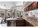 Bright kitchen features sleek countertops, wooden cabinets and a breakfast nook overlooking the pool at 25179 Campos Dr, Punta Gorda, FL 33983