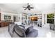 Cozy living room featuring a ceiling fan, modern shelving, and a comfortable gray couch at 25179 Campos Dr, Punta Gorda, FL 33983