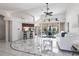 Bright and spacious living room with elegant tile flooring, high ceilings, and pool view at 25179 Campos Dr, Punta Gorda, FL 33983