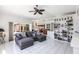 Open-concept living room with pool views, open access to the kitchen, and bright white bookshelves at 25179 Campos Dr, Punta Gorda, FL 33983