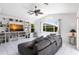 Comfortable living room features built-in bookshelves and a ceiling fan at 25179 Campos Dr, Punta Gorda, FL 33983