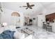 Spacious living room with a view of the dining area, breakfast bar, and the decorative front door at 25179 Campos Dr, Punta Gorda, FL 33983