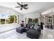 Bright living room with a ceiling fan, a comfortable couch, and a view of the pool at 25179 Campos Dr, Punta Gorda, FL 33983