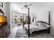 Spacious main bedroom features a four-poster bed, ensuite bathroom, and views of the lanai at 25179 Campos Dr, Punta Gorda, FL 33983