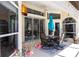 Covered patio with a table set, plants, and multiple access points to the home at 25179 Campos Dr, Punta Gorda, FL 33983