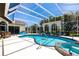 A screened in pool and spa featuring ample lounge space and tropical landscaping at 25179 Campos Dr, Punta Gorda, FL 33983