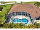 An aerial view shows a screened-in pool and hot tub area at 25179 Campos Dr, Punta Gorda, FL 33983
