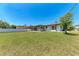 Large, green backyard with a well-maintained lawn and a screened-in lanai at 309 Aurora St, Port Charlotte, FL 33948
