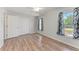 Bedroom featuring hardwood-look floors, ceiling fan, and double closet at 309 Aurora St, Port Charlotte, FL 33948