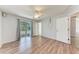Bedroom showcasing wood-look floors, ceiling fan and backyard access at 309 Aurora St, Port Charlotte, FL 33948