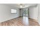 Bright main bedroom showcasing wood-look floors and a sliding glass door leading to a backyard view at 309 Aurora St, Port Charlotte, FL 33948