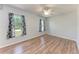 Well-lit bedroom with two windows, wood-look flooring, and a ceiling fan at 309 Aurora St, Port Charlotte, FL 33948