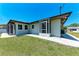 Exterior view of the home with a well-manicured lawn and screened in porch at 309 Aurora St, Port Charlotte, FL 33948