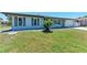 Well-kept single-story home boasts a manicured lawn and shuttered windows at 309 Aurora St, Port Charlotte, FL 33948