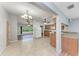 View from the living room into the kitchen that includes stainless steel appliances and breakfast bar at 309 Aurora St, Port Charlotte, FL 33948