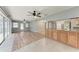 Open concept living room into the kitchen with ceiling fans and sliding glass door to the outside at 309 Aurora St, Port Charlotte, FL 33948