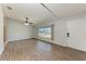 Open living area with modern wood flooring, a large window, and neutral wall paint at 309 Aurora St, Port Charlotte, FL 33948