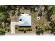 Birds-eye view of the home featuring a metal roof, long drive, and surrounding greenery at 3136 Joshua St, Port Charlotte, FL 33948