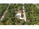 High-angle shot showcases home nestled among lush trees and a winding road at 3136 Joshua St, Port Charlotte, FL 33948