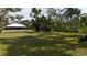 Large private backyard with lush landscaping and mature trees at 3136 Joshua St, Port Charlotte, FL 33948