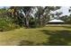 Large private backyard with lush landscaping and mature trees at 3136 Joshua St, Port Charlotte, FL 33948