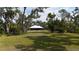 Large private backyard with lush landscaping and mature trees at 3136 Joshua St, Port Charlotte, FL 33948