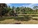 Large private backyard with lush landscaping and mature trees at 3136 Joshua St, Port Charlotte, FL 33948