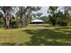 Large private backyard with lush landscaping and mature trees at 3136 Joshua St, Port Charlotte, FL 33948