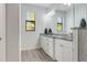 Bathroom featuring a double vanity, granite countertop, and natural light from the window at 3136 Joshua St, Port Charlotte, FL 33948