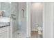 Walk-in shower with marble tile and shower niche, along with a view of the toilet room at 3136 Joshua St, Port Charlotte, FL 33948