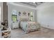 Bright bedroom with a decorative white metal frame bed and natural light from two windows at 3136 Joshua St, Port Charlotte, FL 33948