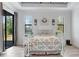 Bright bedroom with a decorative white metal frame bed and a large window at 3136 Joshua St, Port Charlotte, FL 33948
