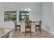 Cozy dining area with table, three chairs, and natural light from a window at 3136 Joshua St, Port Charlotte, FL 33948