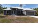Attractive single-story house with neutral paint, new roof, and manicured front landscape at 3136 Joshua St, Port Charlotte, FL 33948