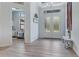 Bright foyer with gray wood floors and stylish decor and an eye to a bedroom at 3136 Joshua St, Port Charlotte, FL 33948