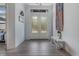 Bright foyer with gray wood floors and stylish decor. Entry way has high ceilings at 3136 Joshua St, Port Charlotte, FL 33948