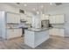 Bright kitchen with white cabinets, stainless steel appliances, granite countertops, and a large island at 3136 Joshua St, Port Charlotte, FL 33948