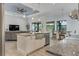 Well-lit kitchen with a central island, stainless steel sink, and open concept design to the living spaces at 3136 Joshua St, Port Charlotte, FL 33948