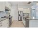 Spacious kitchen with white cabinets, stainless steel appliances, and granite countertops at 3136 Joshua St, Port Charlotte, FL 33948