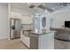 Open kitchen with stainless steel appliances, island with sink, and view into the living room at 3136 Joshua St, Port Charlotte, FL 33948