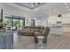 Open living space with a comfortable sectional sofa, natural light, and seamless flow to the kitchen at 3136 Joshua St, Port Charlotte, FL 33948