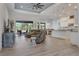 Spacious living room flows to kitchen with an island, lots of windows and views to outside at 3136 Joshua St, Port Charlotte, FL 33948